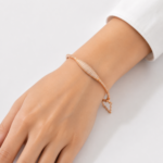 21 Carat Gold-Tone Crystal Pavé Curved Bangle Bracelet with Safety Chain - Image 3